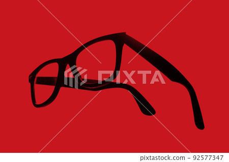 Abstract image of black-rimmed sunglasses seen from an angle Abstract image of black-rimmed sunglasses seen from an angle 92577347