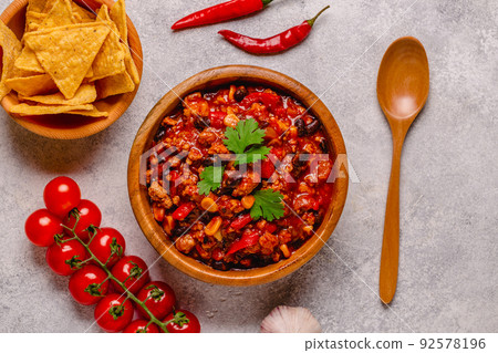 Chili Con Carne in bowl on dark background. Chili Con Carne in bowl on dark background. 92578196