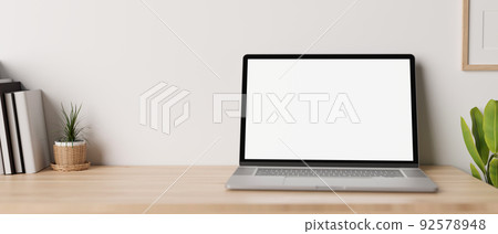 Minimal working desk with opened notebook laptop mockup over white wall. Minimal working desk with opened notebook laptop mockup over white wall. 92578948