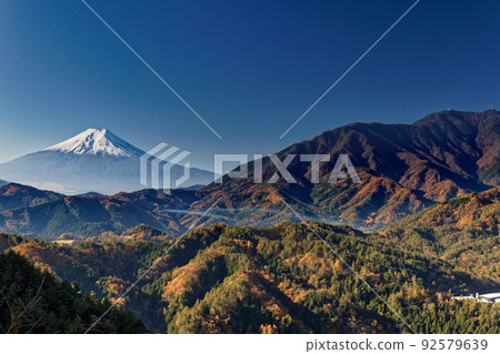 Mountain range of autumn leaves and Mt. Fuji seen from Tenguiwa, Otsuki City 92579639
