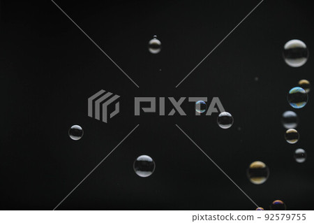 Flying soap bubbles on black background. Abstract soap bubbles with colorful reflections. Soap bubbles in motion background. Flying soap bubbles on black background. Abstract soap bubbles with colorful reflections. Soap bubbles in motion background. 92579755