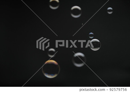 Flying soap bubbles on black background. Abstract soap bubbles with colorful reflections. Soap bubbles in motion background. Flying soap bubbles on black background. Abstract soap bubbles with colorful reflections. Soap bubbles in motion background. 92579756