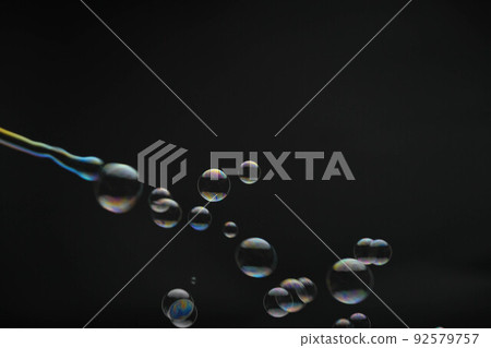 Flying soap bubbles on black background. Abstract soap bubbles with colorful reflections. Soap bubbles in motion background. Flying soap bubbles on black background. Abstract soap bubbles with colorful reflections. Soap bubbles in motion background. 92579757
