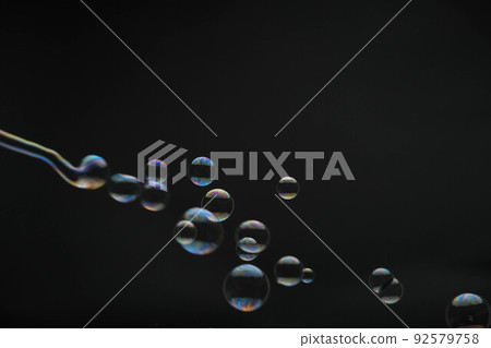 Flying soap bubbles on black background. Abstract soap bubbles with colorful reflections. Soap bubbles in motion background. Flying soap bubbles on black background. Abstract soap bubbles with colorful reflections. Soap bubbles in motion background. 92579758