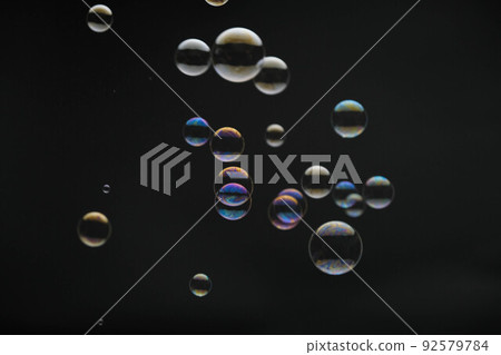 Flying soap bubbles on black background. Abstract soap bubbles with colorful reflections. Soap bubbles in motion background. Flying soap bubbles on black background. Abstract soap bubbles with colorful reflections. Soap bubbles in motion background. 92579784