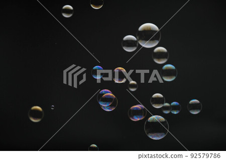 Flying soap bubbles on black background. Abstract soap bubbles with colorful reflections. Soap bubbles in motion background. Flying soap bubbles on black background. Abstract soap bubbles with colorful reflections. Soap bubbles in motion background. 92579786