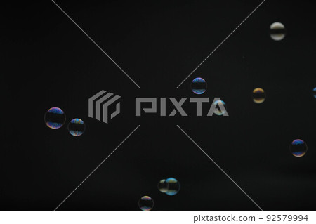 Flying soap bubbles on black background. Abstract soap bubbles with colorful reflections. Soap bubbles in motion background. Flying soap bubbles on black background. Abstract soap bubbles with colorful reflections. Soap bubbles in motion background. 92579994