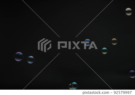 Flying soap bubbles on black background. Abstract soap bubbles with colorful reflections. Soap bubbles in motion background. Flying soap bubbles on black background. Abstract soap bubbles with colorful reflections. Soap bubbles in motion background. 92579997