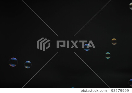 Flying soap bubbles on black background. Abstract soap bubbles with colorful reflections. Soap bubbles in motion background. Flying soap bubbles on black background. Abstract soap bubbles with colorful reflections. Soap bubbles in motion background. 92579999