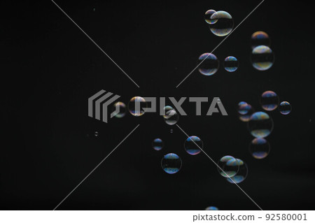 Flying soap bubbles on black background. Abstract soap bubbles with colorful reflections. Soap bubbles in motion background. Flying soap bubbles on black background. Abstract soap bubbles with colorful reflections. Soap bubbles in motion background. 92580001