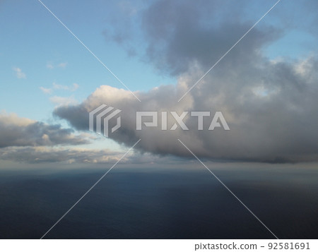 Abstract aerial nature summer ocean sunset sea and sky background. Small waves on clear water surface in motion blur with bokeh lights from sunrise. Holiday, vacation and recreational concept Abstract aerial nature summer ocean sunset sea and sky background. Small waves on clear water surface in motion blur with bokeh lights from sunrise. Holiday, vacation and recreational concept 92581691