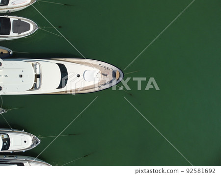Aerial panoramic view of Balaklava landscape with boats and sea in marina bay. Crimea Sevastopol tourist attraction. Drone top view shot of port for luxury yachts, boats and sailboats. Aerial panoramic view of Balaklava landscape with boats and sea in marina bay. Crimea Sevastopol tourist attraction. Drone top view shot of port for luxury yachts, boats and sailboats. 92581692