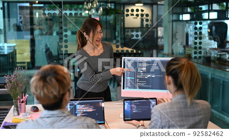 Young AI programmers and IT software developers team doing code programming, brainstorming for new web site project together 92582462