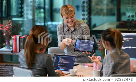 Team of young professionals doing code programming, brainstorming for new web site project together 92582478