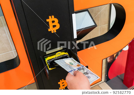Atm bitcoin cryptocurrency machine. Woman withdraw american dollar bill cash. Usd hundred money payment on virtual crypto currency btc wallet. Bitcoin BTC ATM Cash Machine. 92582770