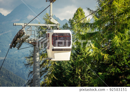 gondola ski lift in mountain ski resort, green forest gondola ski lift in mountain ski resort, green forest 92583151