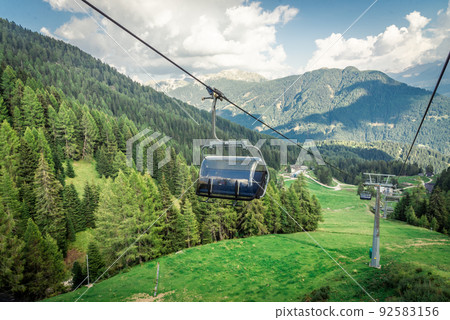 gondola ski lift in mountain ski resort, green forest gondola ski lift in mountain ski resort, green forest 92583156