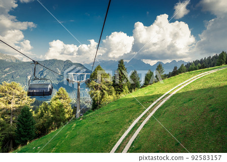 gondola ski lift in mountain ski resort, green forest gondola ski lift in mountain ski resort, green forest 92583157