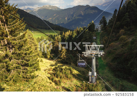 gondola ski lift in mountain ski resort, green forest gondola ski lift in mountain ski resort, green forest 92583158