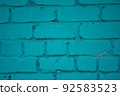 Brick wall close-up. The brick wall painted in blue. Place for text. Empty space 92583523