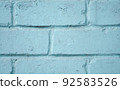 Brick wall close-up. The brick wall painted in blue. Place for text. Empty space 92583526