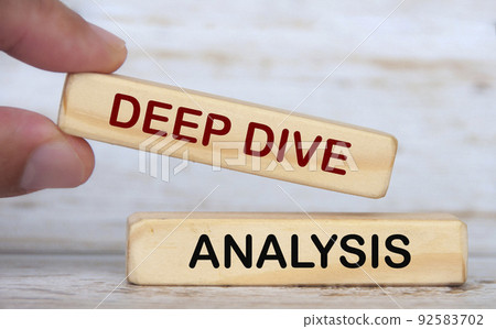 Hand holding wooden blocks with text - Deep dive analysis. 92583702