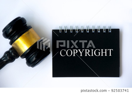 Copyright law text on black notepad and gavel on white background cover. Copyright law text on black notepad and gavel on white background cover. 92583741