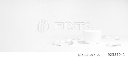 Mockup of a white jar of cream on a white and gray background, on a white table with mineral salt stones, with hard shadows. Stylish product appearance, personality. Banner Mockup of a white jar of cream on a white and gray background, on a white table with mineral salt stones, with hard shadows. Stylish product appearance, personality. Banner 92585041