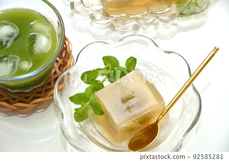 Agar and sweets with plums on glass tableware 92585281