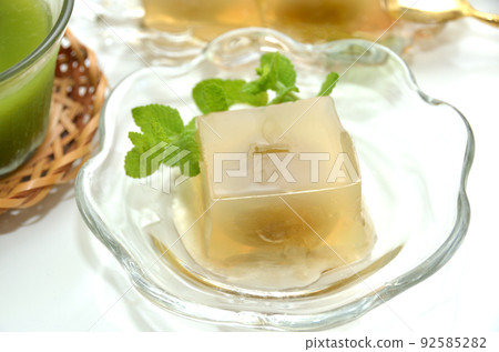 Agar and sweets with plums on glass tableware 92585282