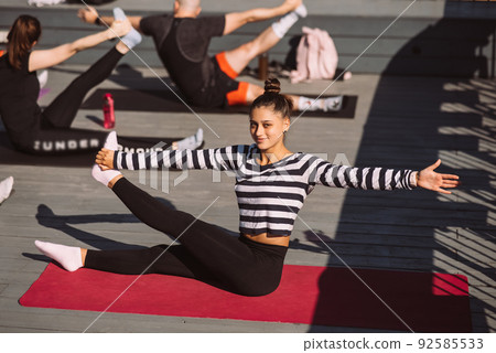 Yogi woman and diverse group of sporty people practicing yoga Yogi woman and diverse group of sporty people practicing yoga 92585533