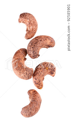 Cashew nuts in shell isolated on white background. Roasted and salted cashew nuts. Top view. Cashew nuts in shell isolated on white background. Roasted and salted cashew nuts. Top view. 92585901
