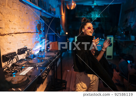 Beautiful female dancing in a small club Beautiful female dancing in a small club 92586119