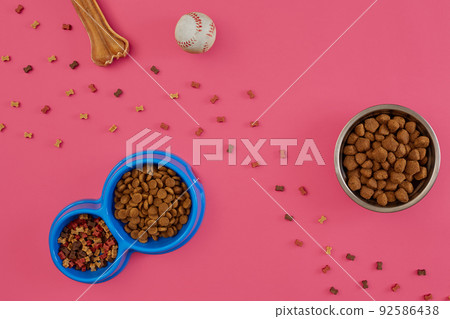 Dog snacks, dog chews, dog bone, ball toy for dog on a pink background with copy space Dog snacks, dog chews, dog bone, ball toy for dog on a pink background with copy space 92586438