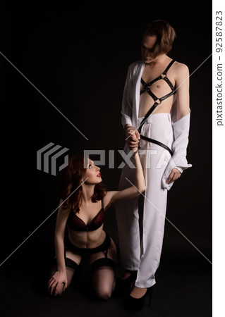 Sensual BDSM couple with slavery woman and transvestite man 92587823