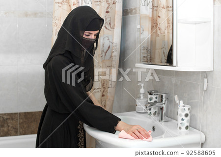 Muslim housewife cleans up the bathroom Muslim housewife cleans up the bathroom 92588605