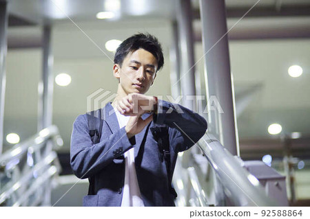 Young businessman and night station Young businessman and night station 92588864