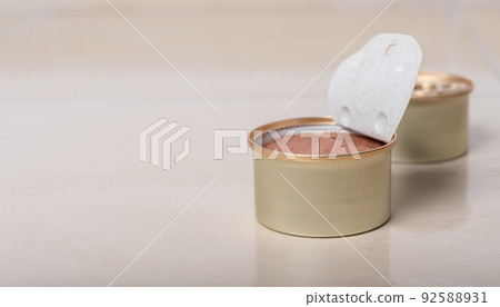 Cat food in the form of a pate in an open tin. Cat food in the form of a pate in an open tin. 92588931
