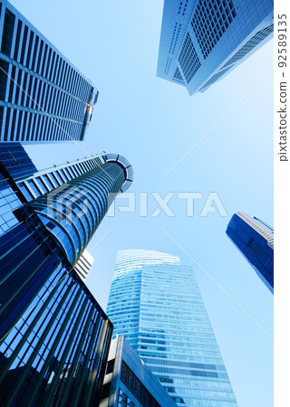 low angle view of singapore city buildings against blue sky low angle view of singapore city buildings against blue sky 92589135