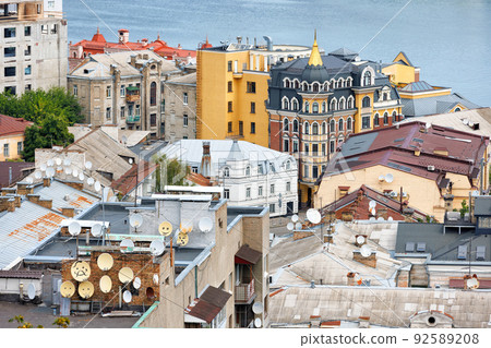 Satellite dishes on the roof of old city houses. Satellite dishes on the roof of old city houses. 92589208