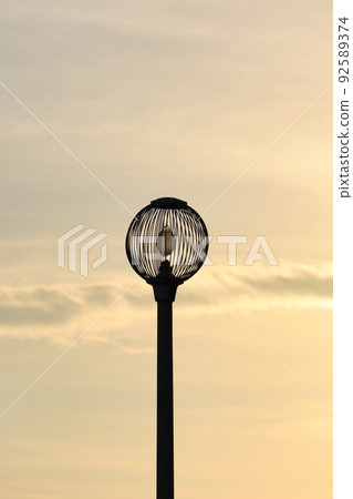 Silhouette of sunset sky and round streetlights 92589374