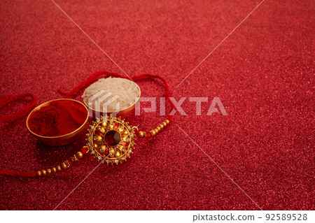 Indian festival Raksha Bandhan with wrist band Rakhi, Rice Grains and Kumkum. 92589528