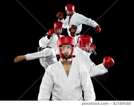 Taekwondo fighter in white dobok, helmet and gloves training isolated over dark background. Collage, poster. Concept of sport, workout, health. 92589580