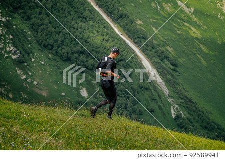 male runner run trail during ultramarathon male runner run trail during ultramarathon 92589941