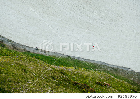woman and man athletes run on snowy slope during marathon woman and man athletes run on snowy slope during marathon 92589950
