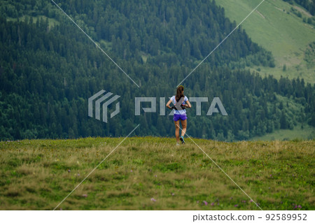female trail runner running ultramarathon race female trail runner running ultramarathon race 92589952