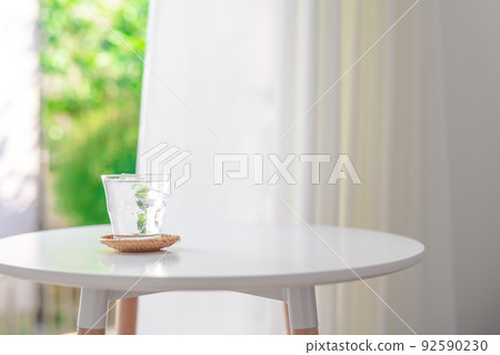 Ice water by a bright window 92590230