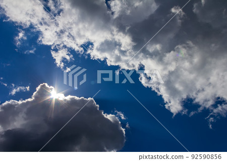 landscape with blue sky, storm clouds and sun 92590856