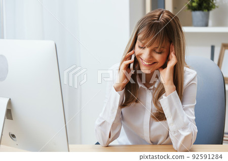 Smiling happy adorable blonde businesswoman worker freelancer talking with client in call in light modern office. Enjoyed employee work on computer online in support service. Copy space 92591284