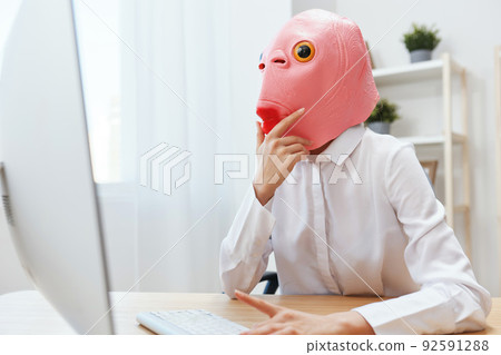 Thoughtful crazy businesswoman worker freelancer in pink fish mask work on computer online pondering or making decision thinking of problem solution touch head in light modern office. Copy space Thoughtful crazy businesswoman worker freelancer in pink fish mask work on computer online pondering or making decision thinking of problem solution touch head in light modern office. Copy space 92591288